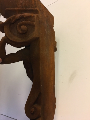 Very striking wall bracket -ornament with garing man, Polystone rest.